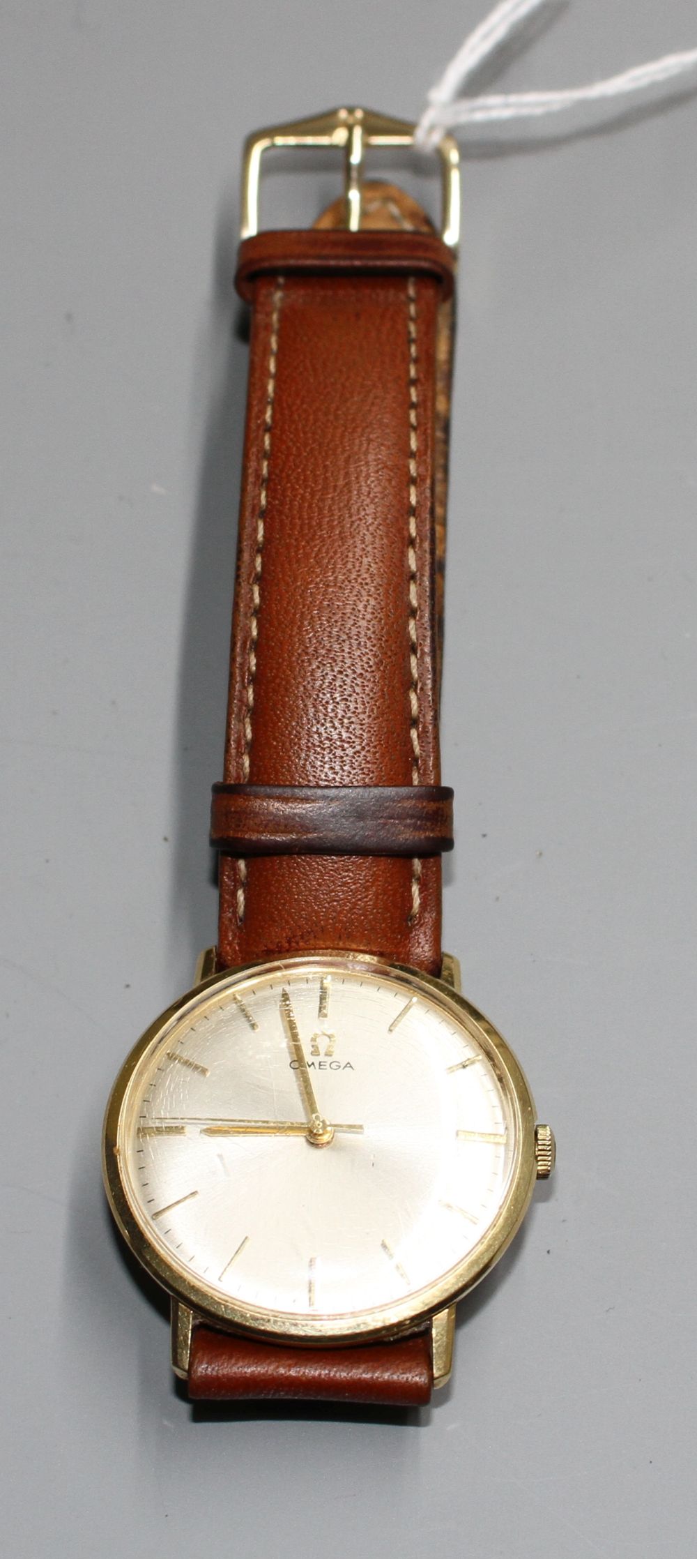 A gentlemans Omega manual wind wrist watch, on associated strap,